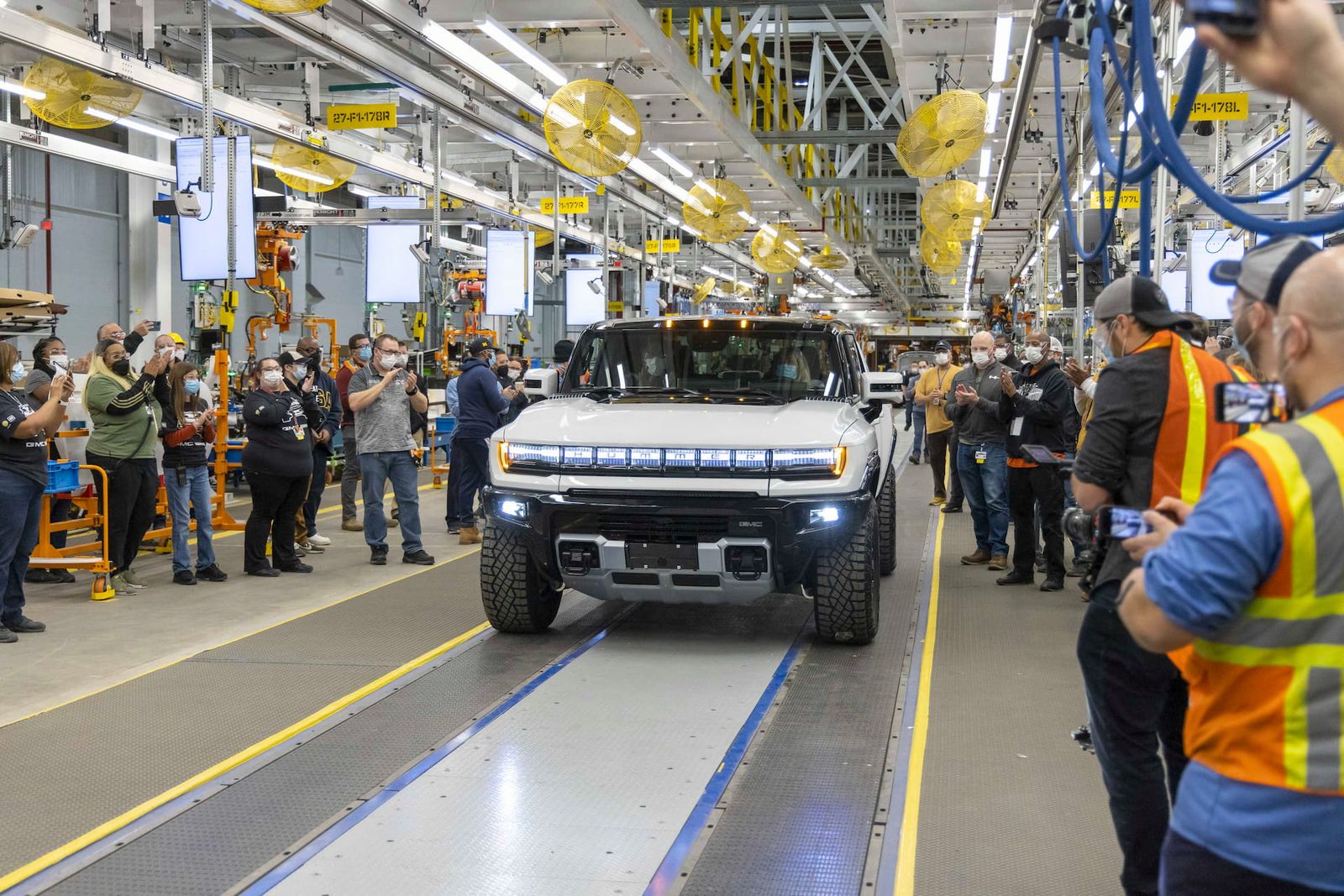 Workers celebrate the first GMC Hummer EV to roll off an assembly line. GM abandoned plans to build 400,000 EVs from 2022 to mid-2024.