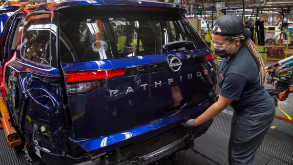 A worker inspects Nissan Pathfinder SUV at the company's Smyrna Vehicle Assembly Plant in Tennessee.