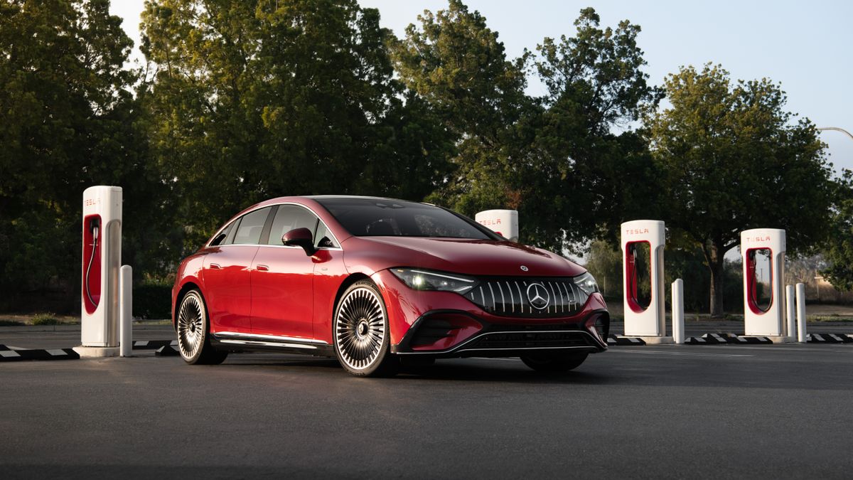 A Mercedes-Benz electric vehicle parked at a Tesla Supercharger location.