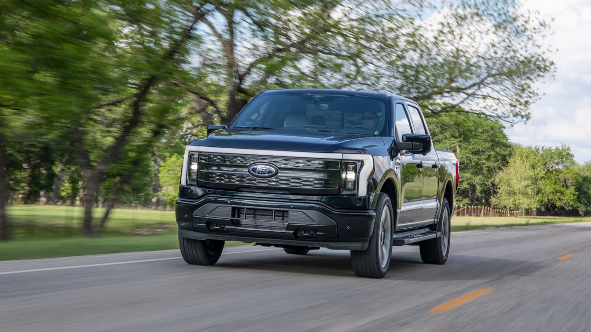 A Ford F-150 Lightning electric pickup on the road.